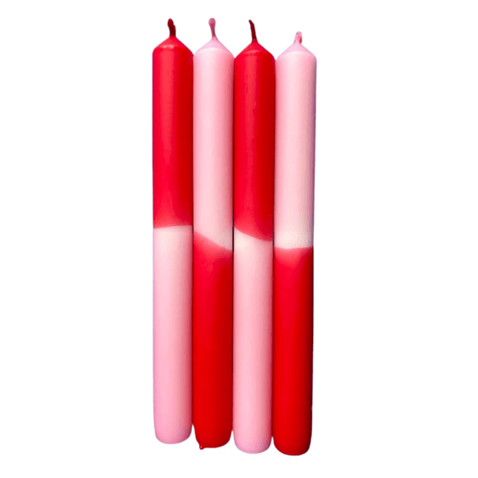 Four red and pink gradient candles on a white background