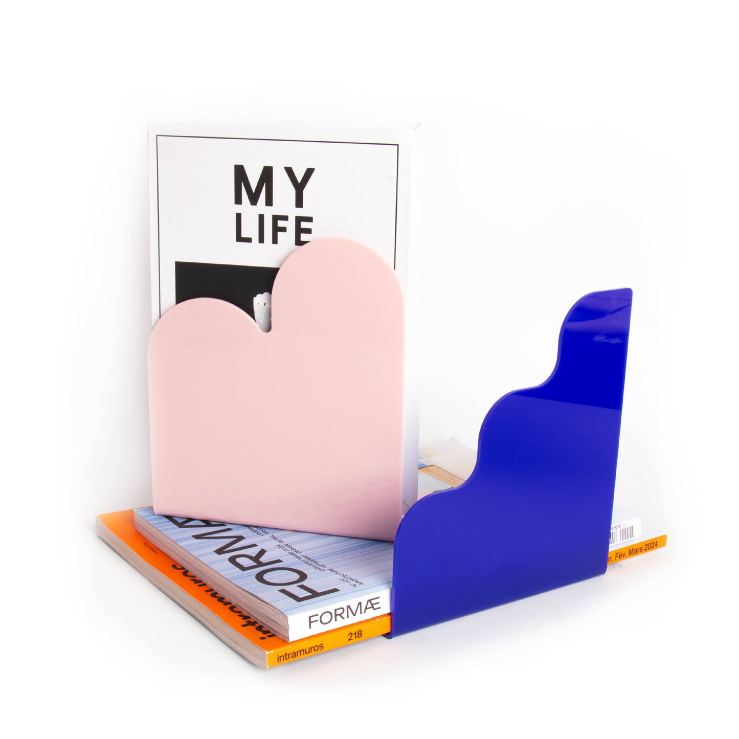 Colorful bookends holding open a magazine titled 'My Life' on a white background