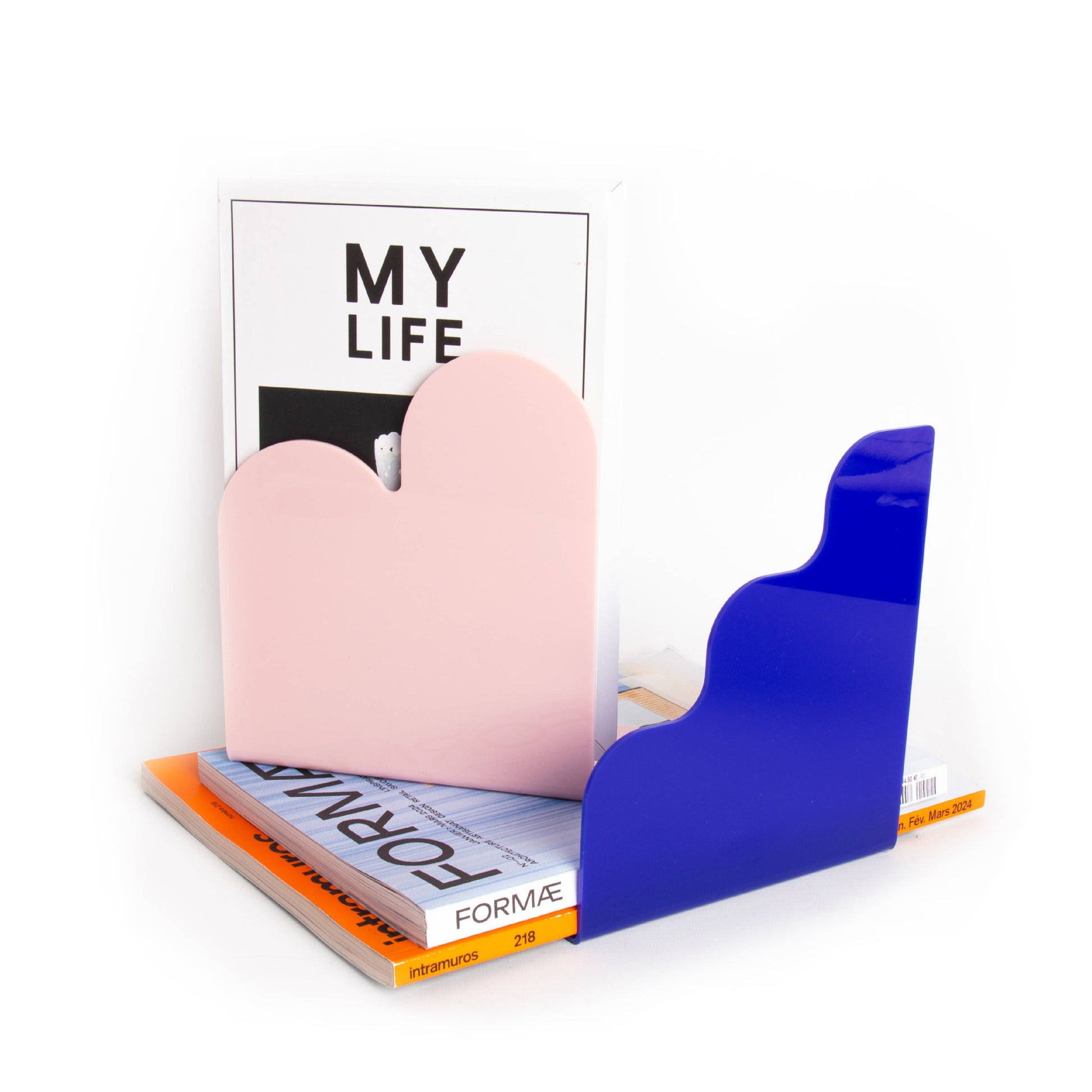 Colorful bookends holding open a magazine titled 'My Life' on a white background